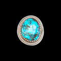 Turquoise stone ring with silver band on a black background