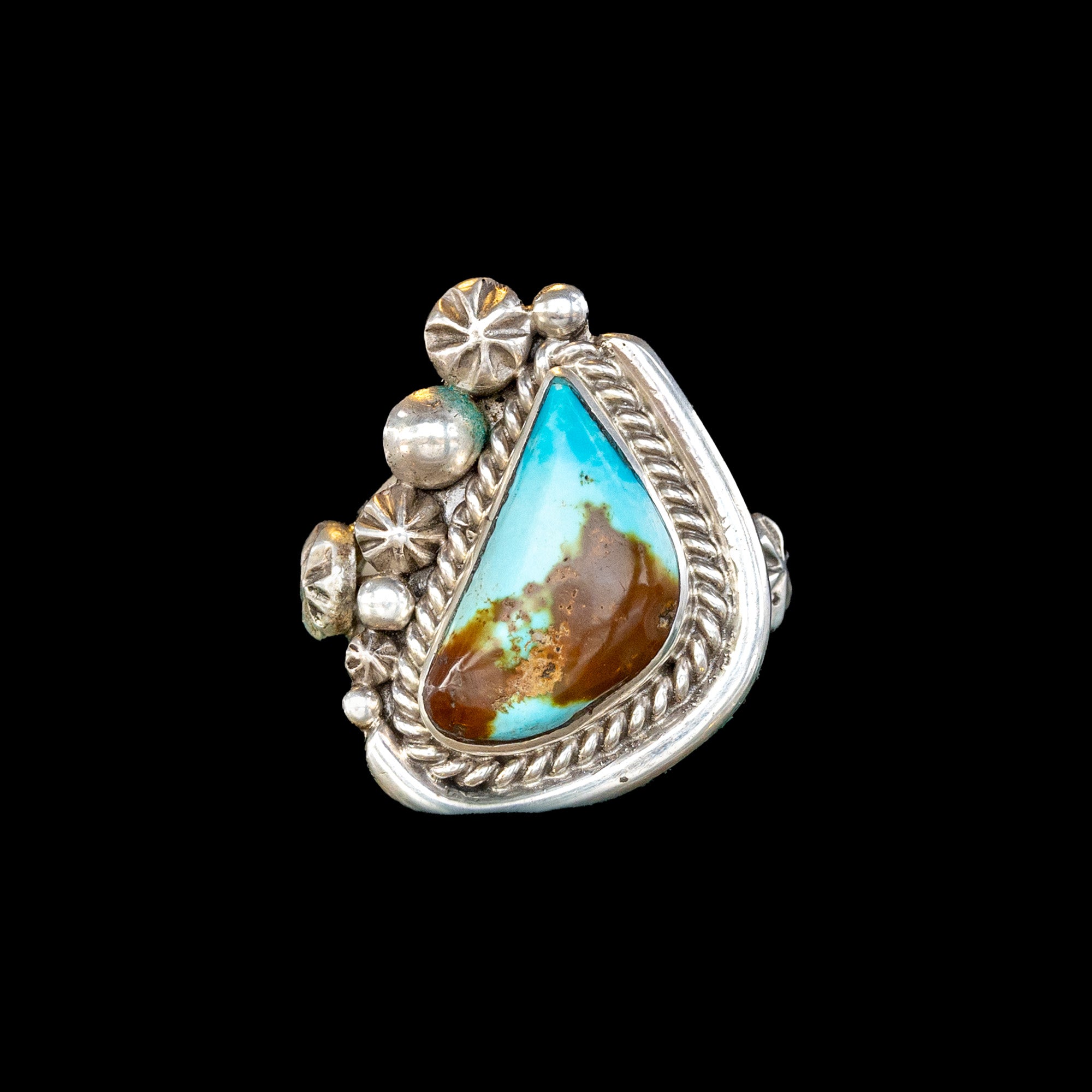 Silver ring with a turquoise stone on a black background