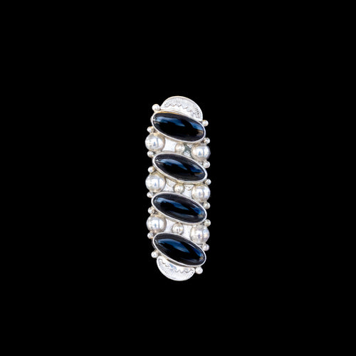 Vertically set ring with black stones set in sterling silver on black background
