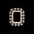 Square framed  onyx with black and silver beads  on a black background