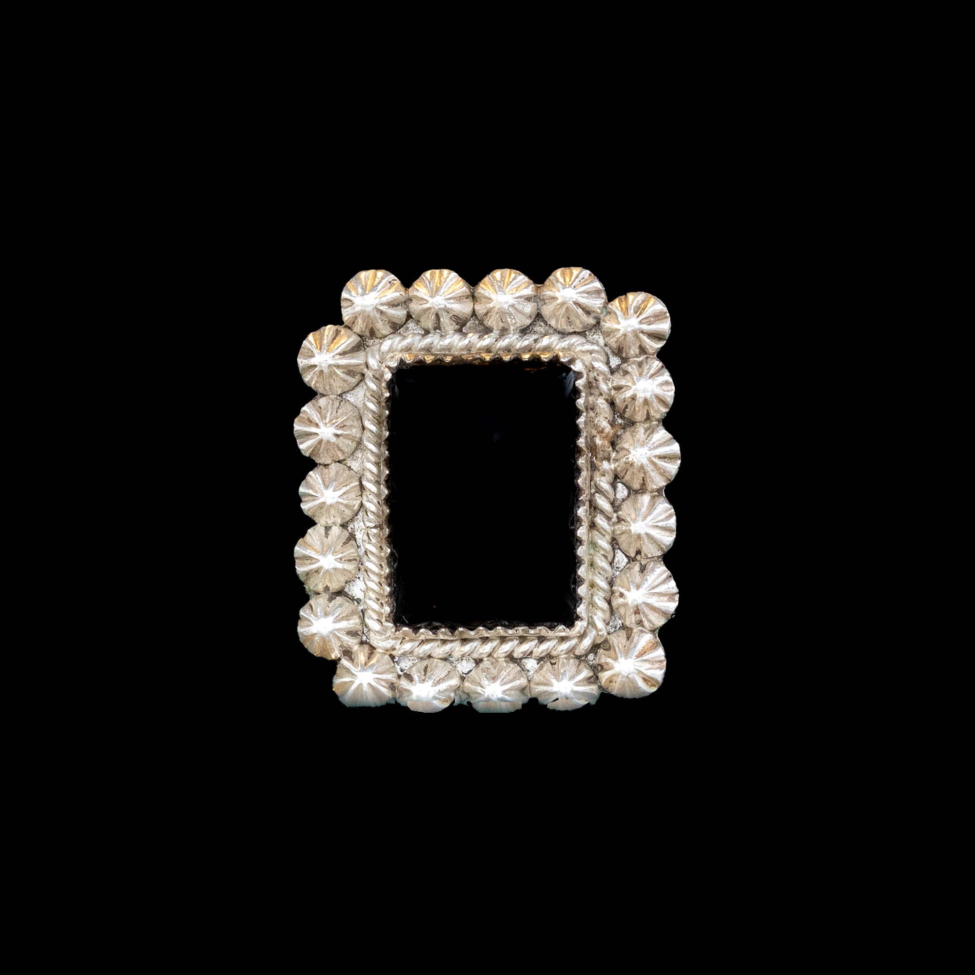 Decorative silver frame of black onyx ring on a black background