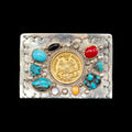 Decorative belt buckle with gold coin, colored stones, and silver embellishments on a black background