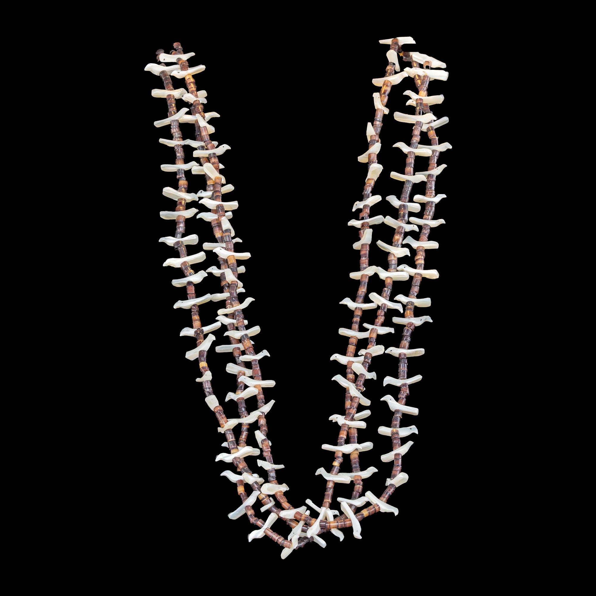 Necklace with beads and mother of pearl birds on a black background