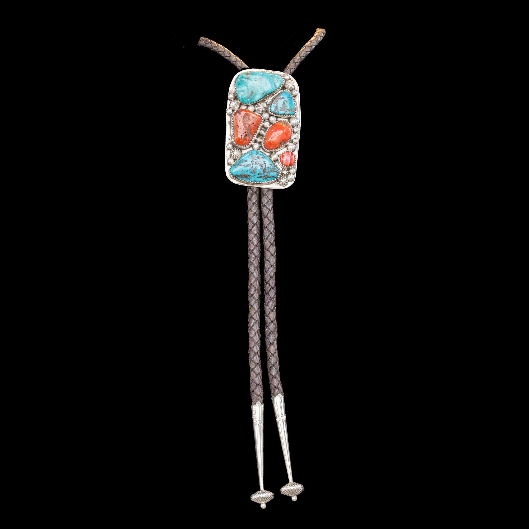 Bolo tie with colorful stone design on a black background