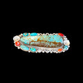 Double ring with turquoise stones and red coral on a black background