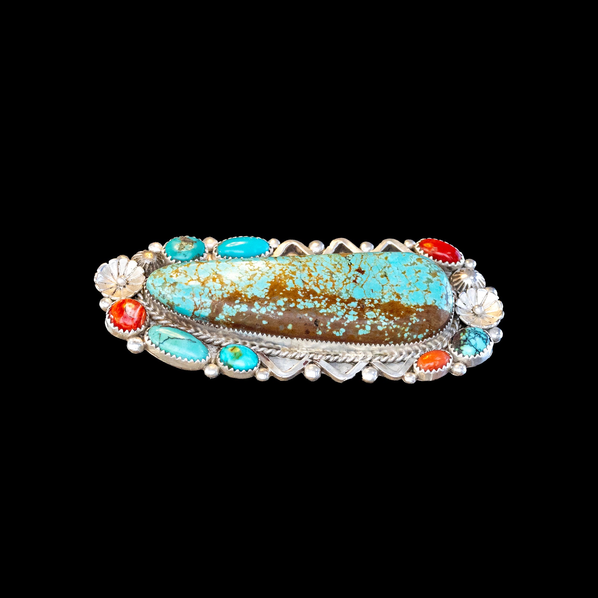 Double ring with turquoise stones and red coral on a black background
