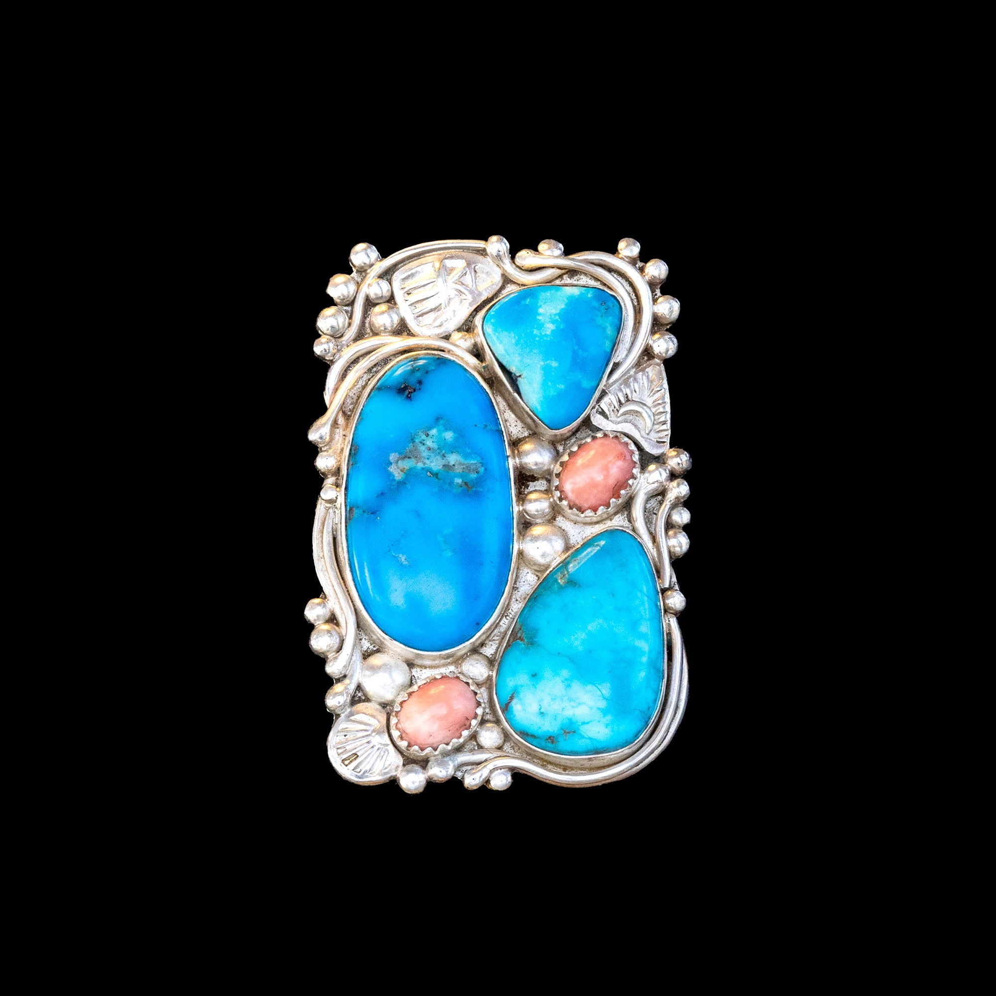 Sterling Silver ring with blue turquoise and pink coral on a black background